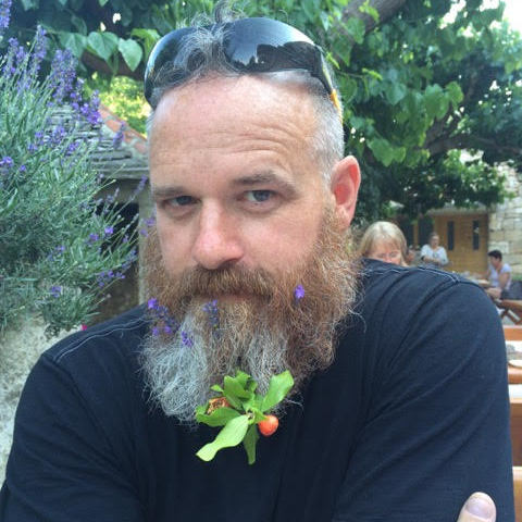 Matt Honan with flowers in his beard